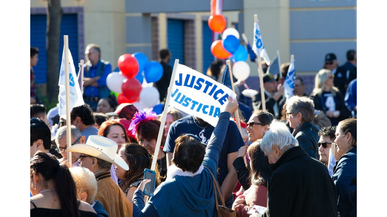 Supporters hold up signs as Juliàn Castro announces his candidacy for president of the United States 