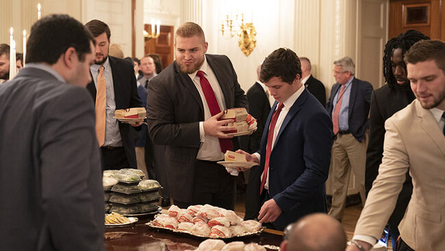 Members of the Clemson Tigers football team prepare to dine on fast food served by President Trump to celebrate their Championship at the White House