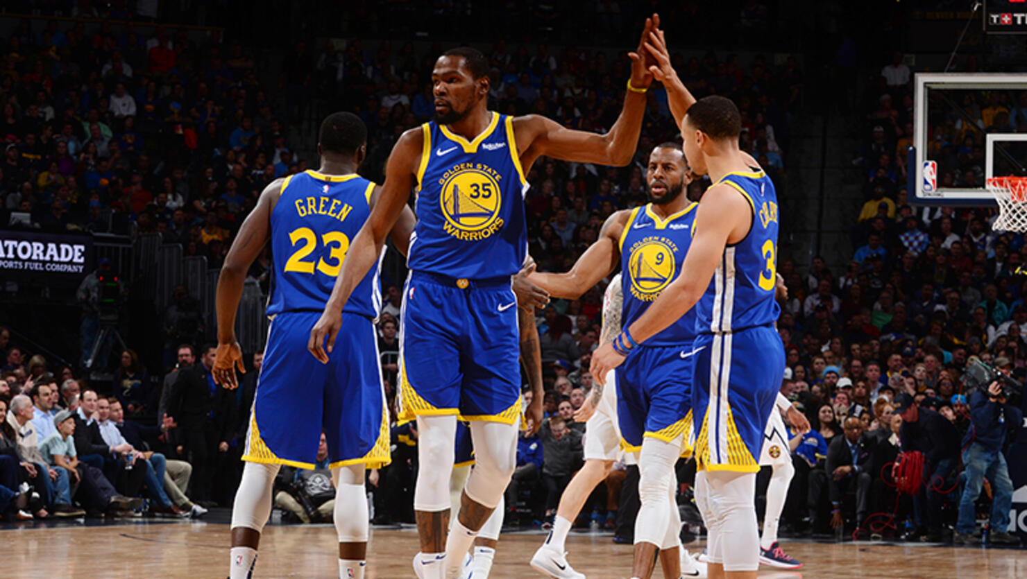 Kevin Durant #35 hi-fives Stephen Curry #30 of the Golden State Warriors