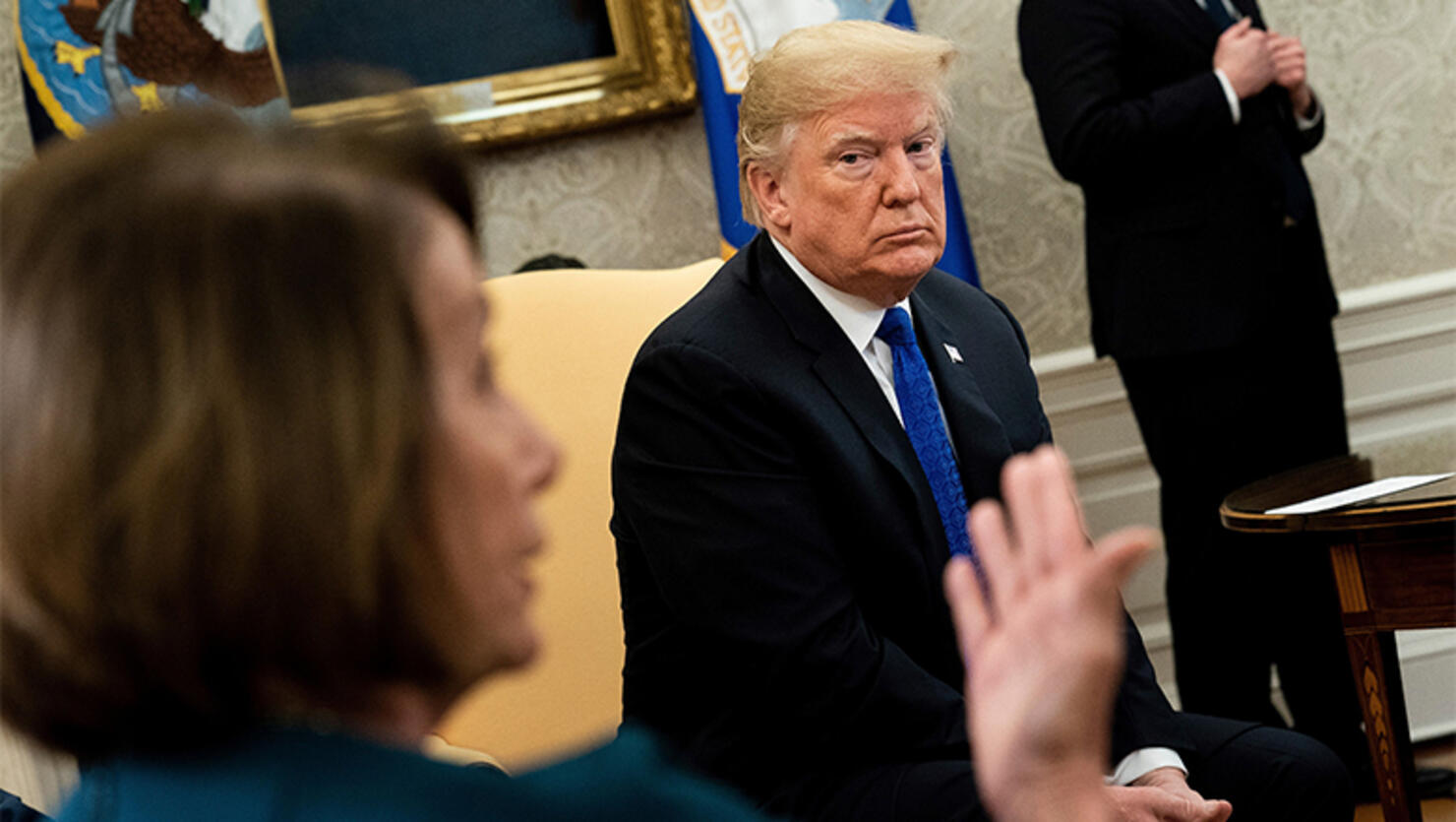 US President Donald Trump (R) listens while presumptive Speaker, House Minority Leader Nancy Pelosi (D-CA) makes a statement to the press before a meeting at the White House December 11, 2018 in Washington, DC