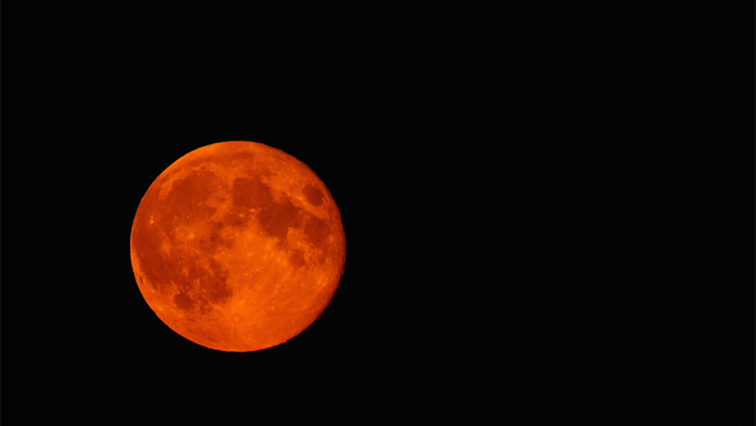 A blood red Super moon is seen rising in the sky