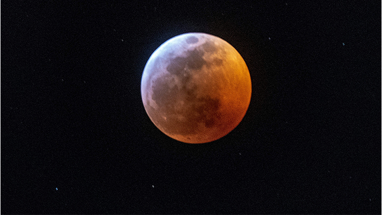 Earth's shadow almost totally obscures the view of the so-called Super Blood Wolf Moon during a total lunar eclipse, on Sunday January 20, 2019, in Miami, Florida