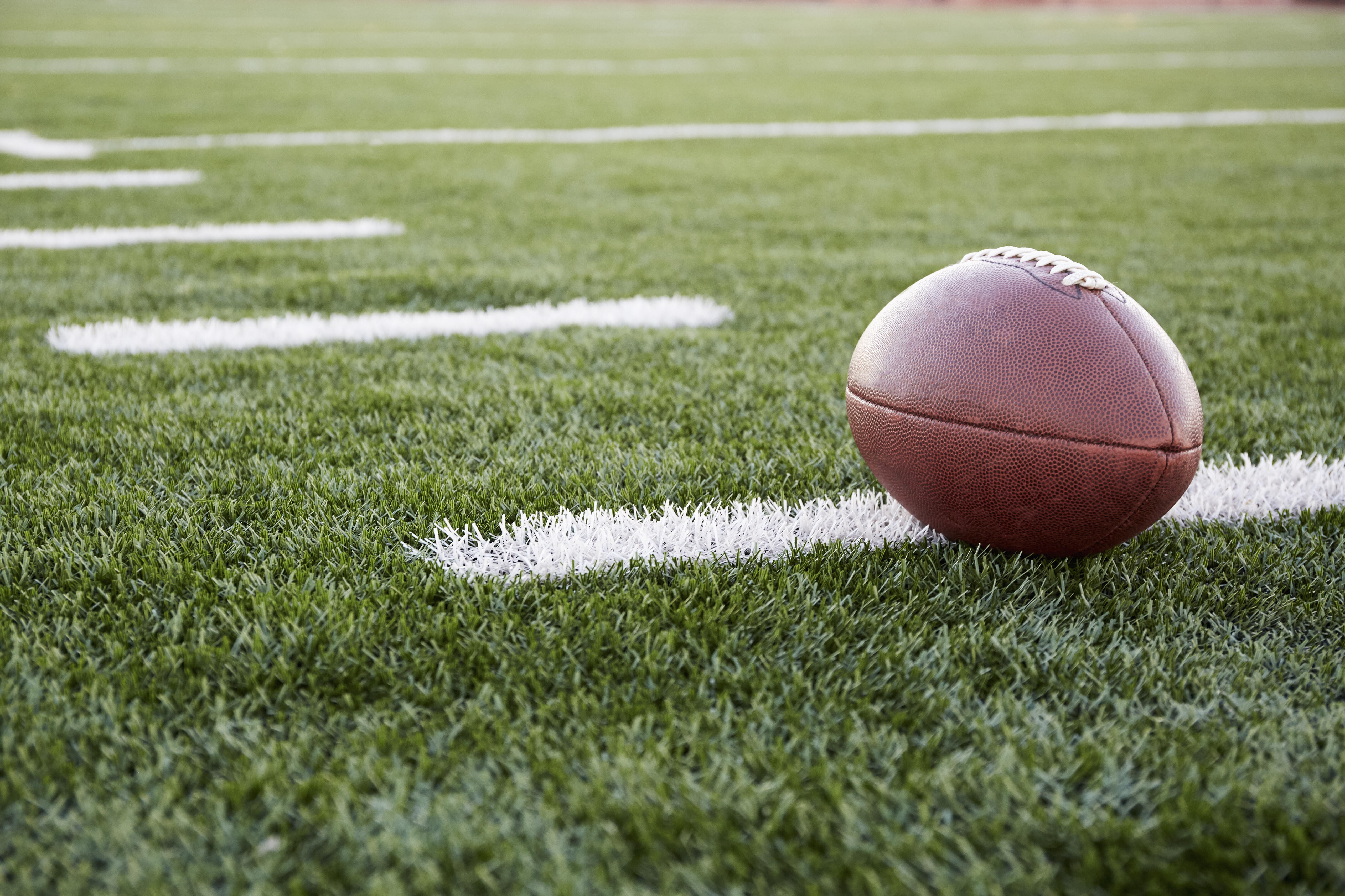 He loves football. Мяч для американского футбола. Поле для американского футбола. Мяч для американского футбола на траве. Мяч для американского футбола Эстетика.