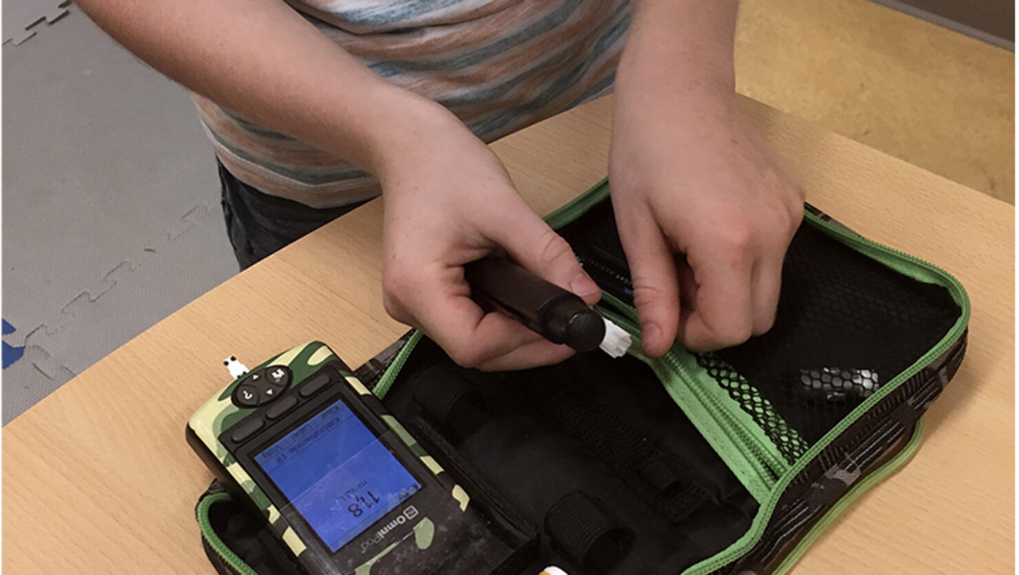 Dutch boy Ruben van As, 7, who has childhood diabetes, shows off his life-saving kit which he carries with him all the time and can show him immediately how high his blood sugar levels are and if he needs to adjust his insulin