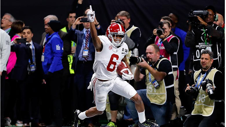  DeVonta Smith #6 of the Alabama Crimson Tide celebrates catching a 41 yard touchdown pass to beat the Georgia Bulldogs in the CFP National Championship presented by AT&T in overtime at Mercedes-Benz Stadium on January 8, 2018 in Atlanta, Georgia