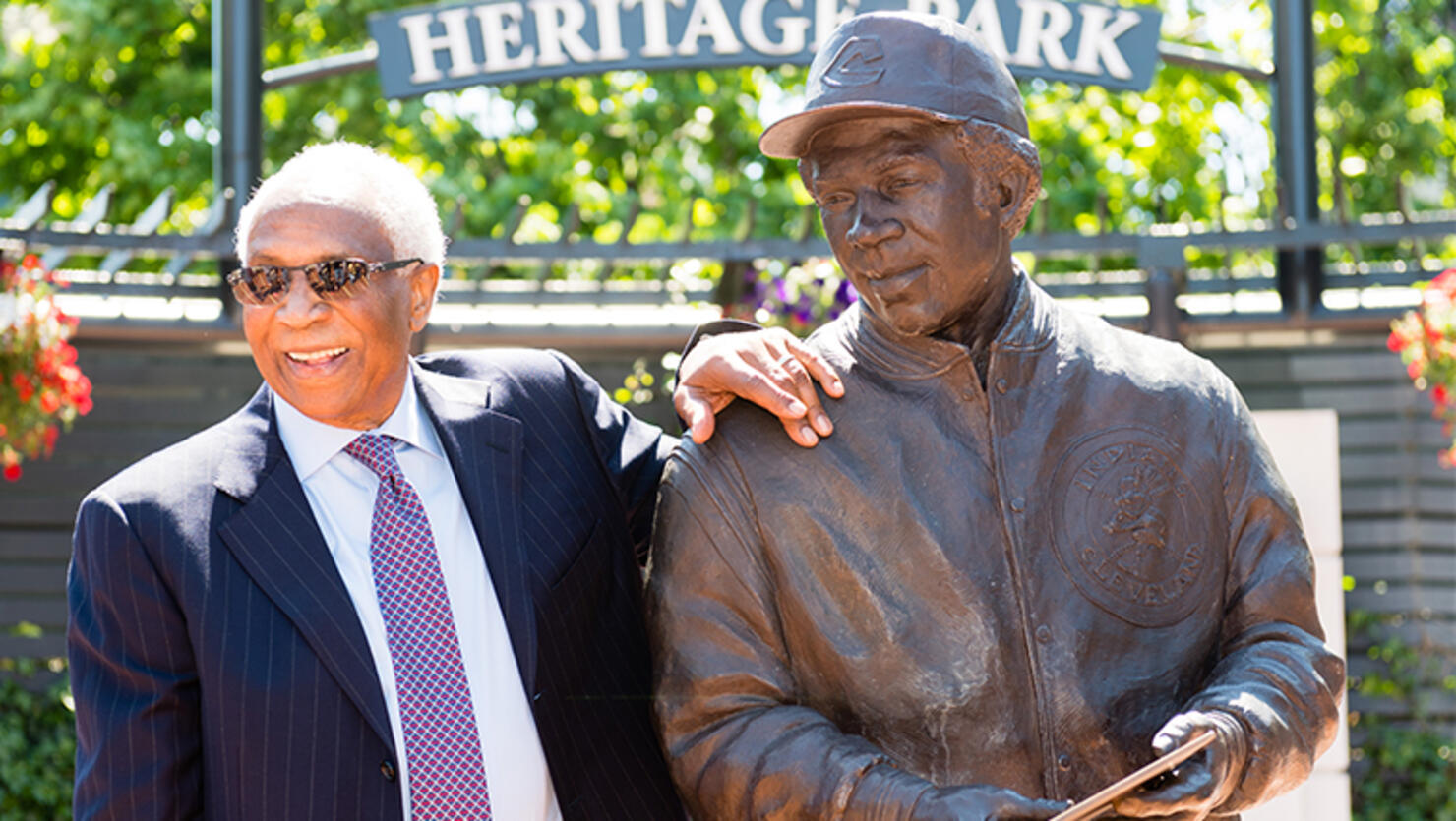 Former Cleveland Indians manager and player Frank Robinson stands with a new statue commemorating his career