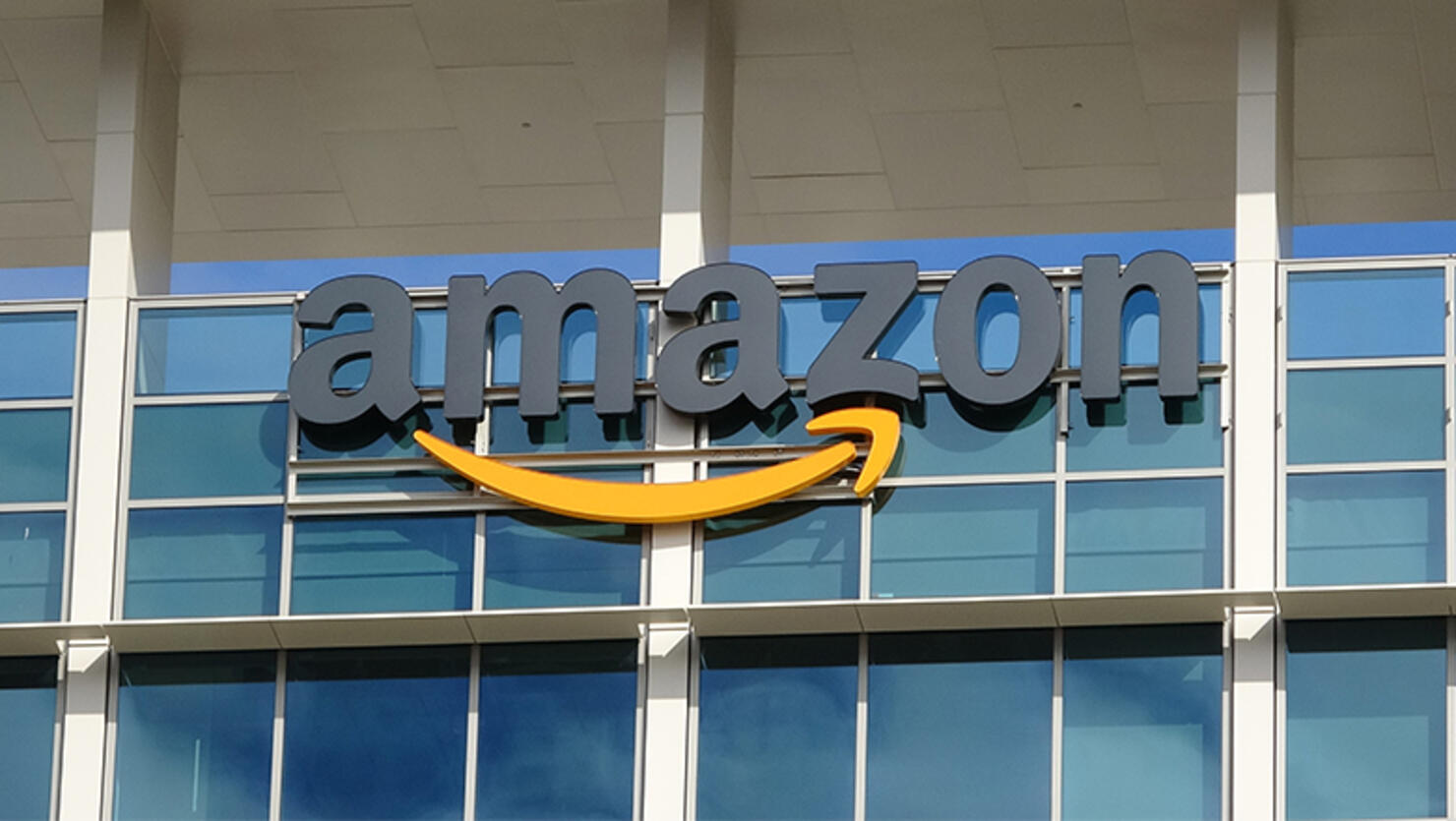 Close-up of sign with logo on facade of the regional headquarters of ecommerce company Amazon in the Silicon Valley town of Sunnyvale, California