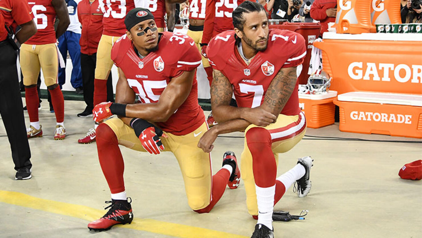 Colin Kaepernick #7 and Eric Reid #35 of the San Francisco 49ers kneel in protest during the national anthem prior to playing the Los Angeles Rams in their NFL game at Levi's Stadium