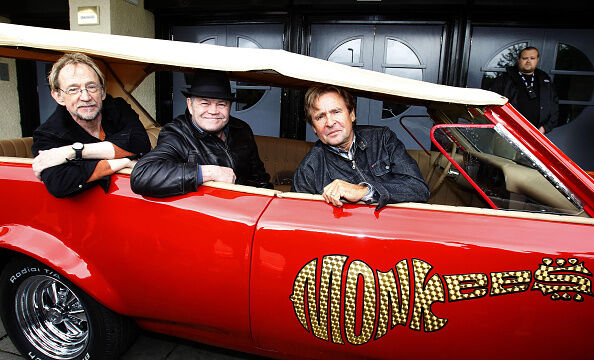 The Monkees minus Mike Nesmith in their famous TV car.