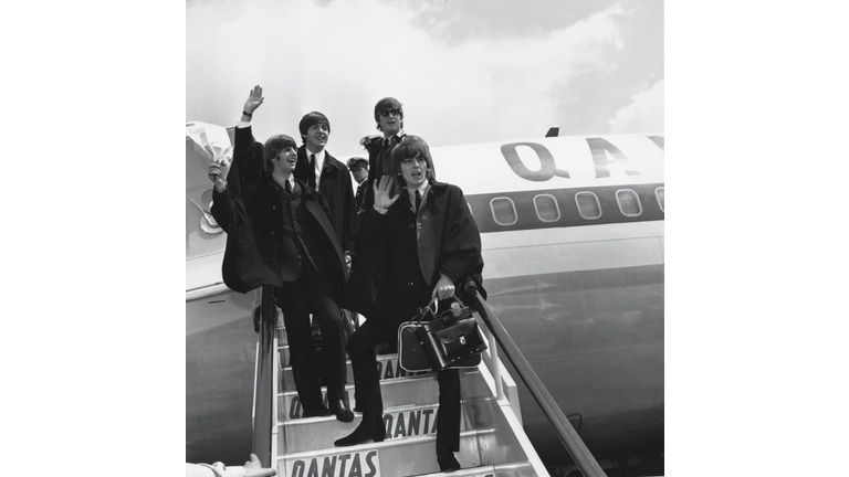 The Beatles (L to R) Ringo Starr, Paul McCartney, John Lennon and George Harrison wave to fans July 2, 1964 as they return to London from a tour of Australia. Photo by Getty Images