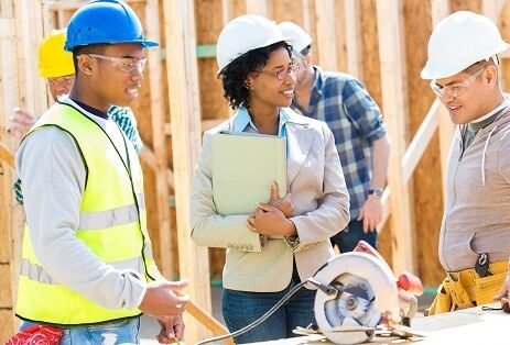 Construction workers meet with home builder