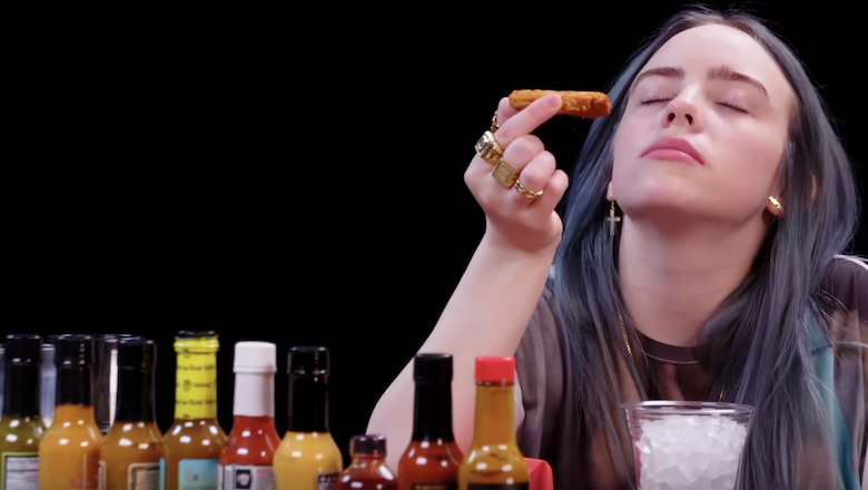 Billie Eilish Talks Love Hate And Art While Eating Hot Vegan Wings Watch Iheart