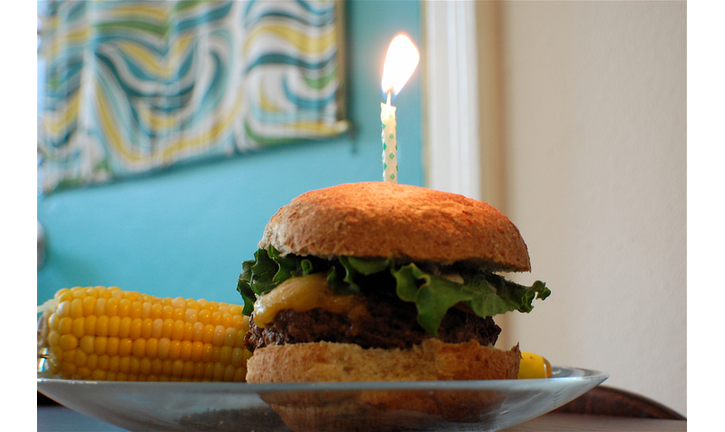 Cheeseburger with one birthday candle