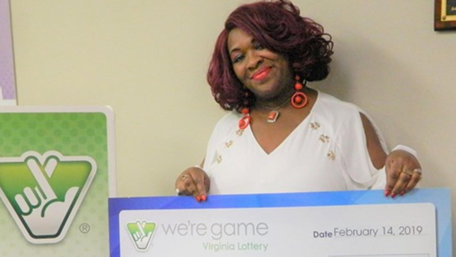 Deborah Brown holds a giant check after winning the lottery in Virginia