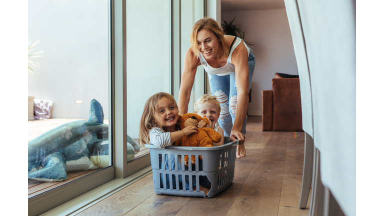 Mother playing with her children at home