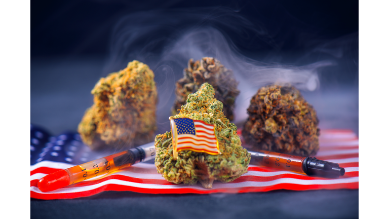 Cannabis buds, oil and american flag assortment - veteran medical marijuana concept