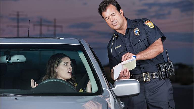 Police Officer Explaining Citation to Woman Driver