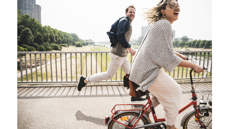 Happy couple crossing a bridge
