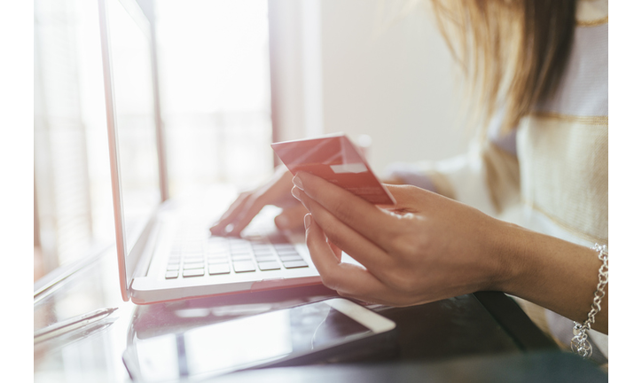 Close-up of woman buying from home on the laptop