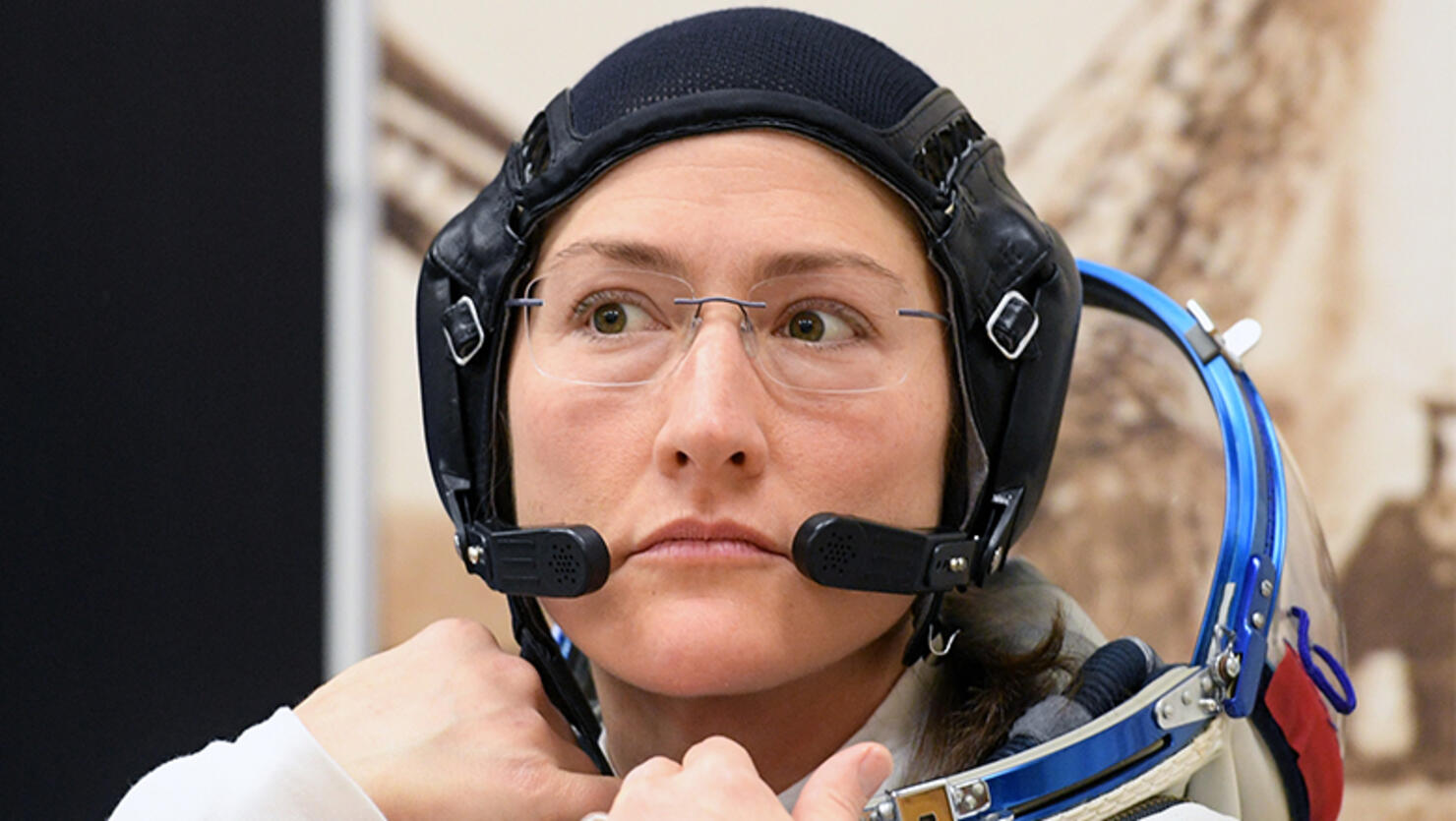 NASA astronaut Christina Hammock Koch, a member of the International Space Station (ISS) expedition 59/60, looks on as her spacesuit is tested prior to the launch onboard the Soyuz MS-12 spacecraft from the Russian-leased Baikonur cosmodrome in Kazakhstan 