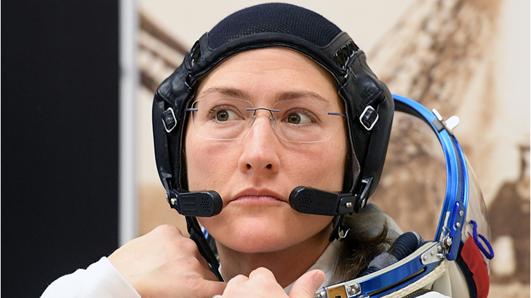 NASA astronaut Christina Hammock Koch, a member of the International Space Station (ISS) expedition 59/60, looks on as her spacesuit is tested prior to the launch onboard the Soyuz MS-12 spacecraft from the Russian-leased Baikonur cosmodrome in Kazakhstan 