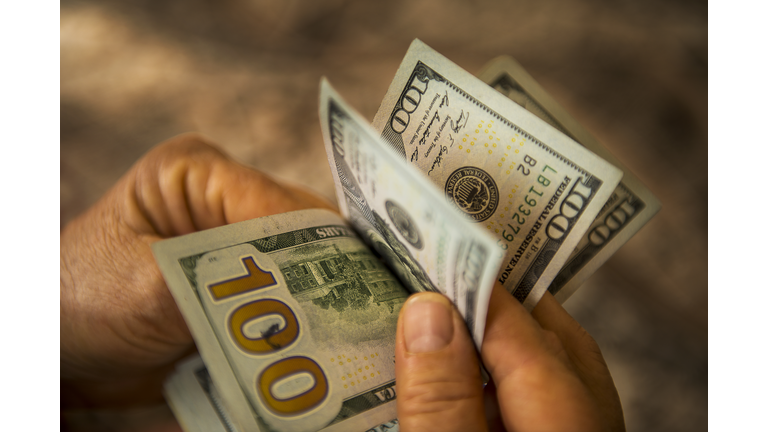 Unrecognizable mature man counting USA Dollar bills