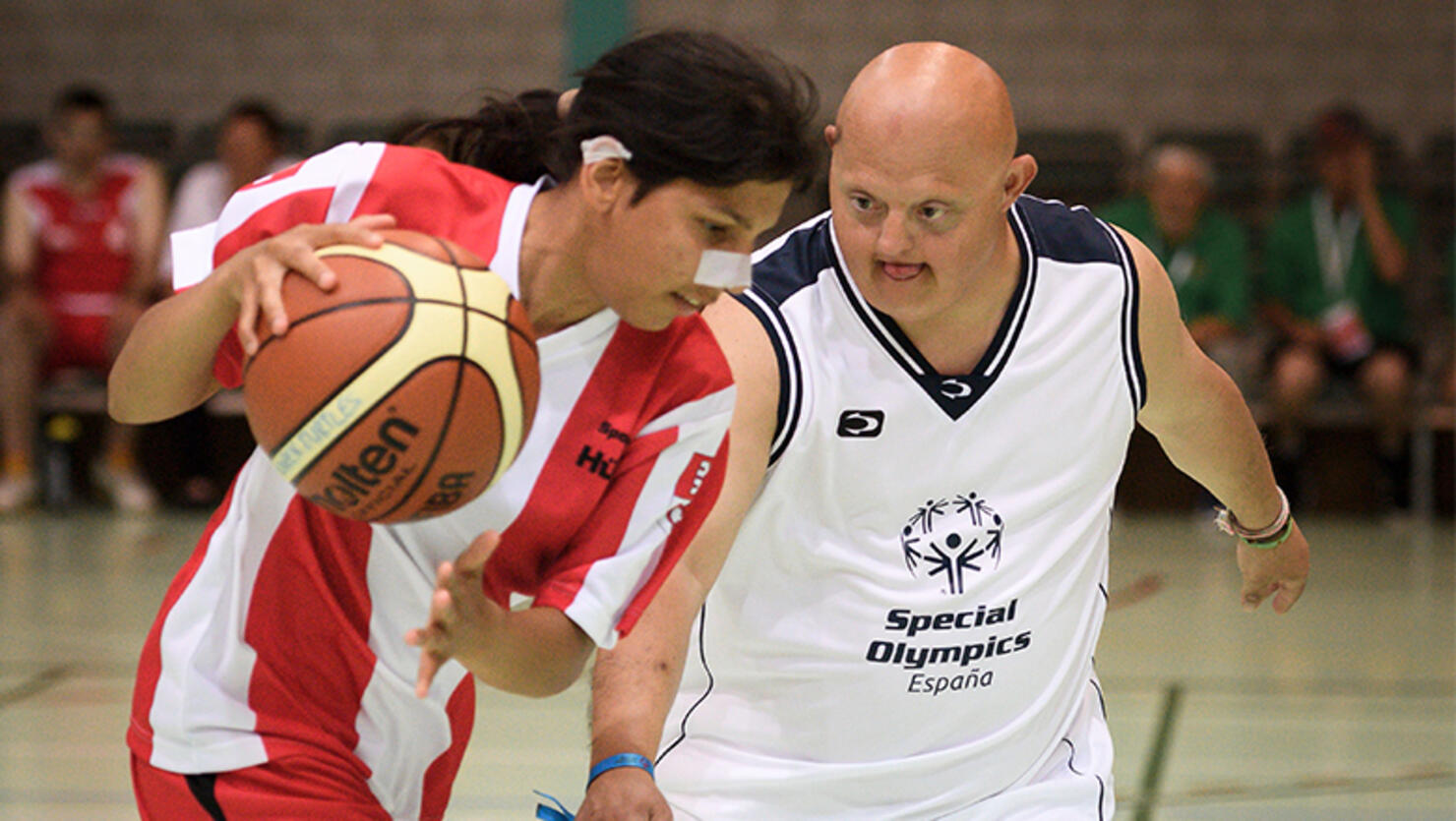 Basketball players challenge during a match between Swiss Sportclub Huetli and a Team Spain at the national games, part of the Special Olympics, the world's largest sports organization for children and adults with intellectual disabilities