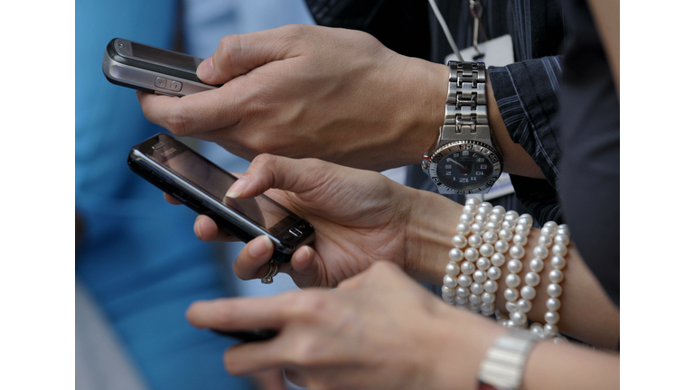 Shoppers at a mall send text messages us