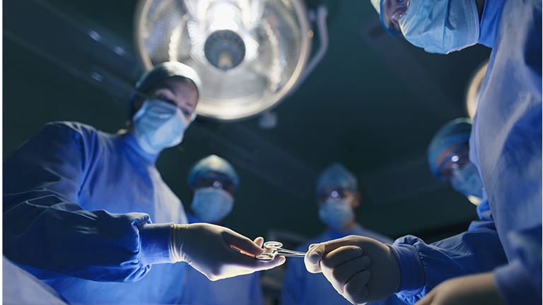 Operating room staff performing hospital surgery