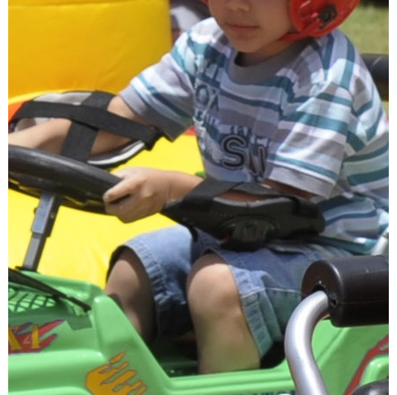 Children ride toys rally vehicles during