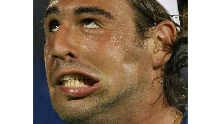 Marcos Baghdatis of Cyprus pulls a stran