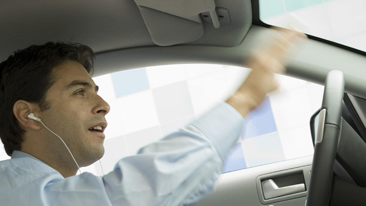 Businessman Listening to His MP3 Player While Driving