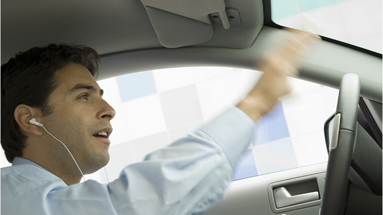 Businessman Listening to His MP3 Player While Driving