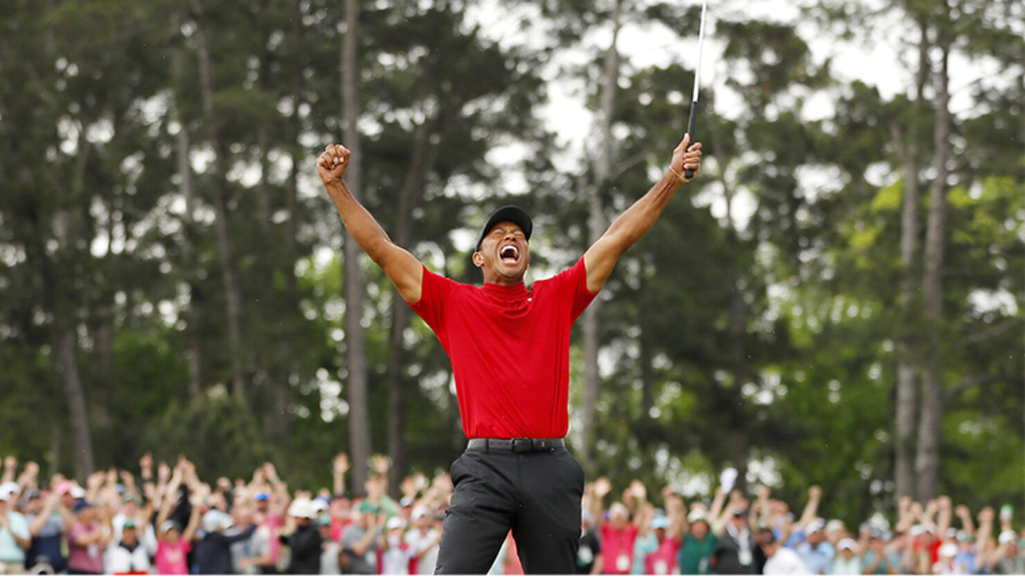 Tiger Woods of the United States celebrates after sinking his putt on the 18th green to win during the final round of the Masters at Augusta National Golf Club on April 14, 2019