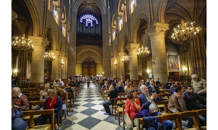 Tourists visiting the Notre Dame de Paris on september 25, 2013 in Paris. The cathedral of Notre Dame is one of the top tourist destinations in Paris