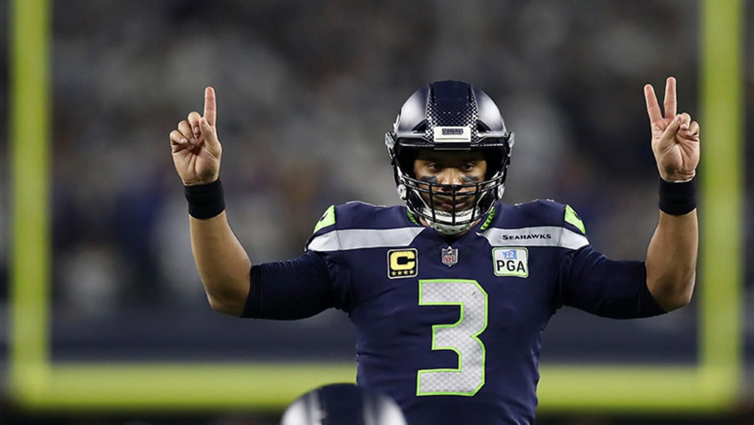 Russell Wilson #3 of the Seattle Seahawks gestures before a play in the third quarter against the Dallas Cowboys during the Wild Card Round at AT&T Stadium