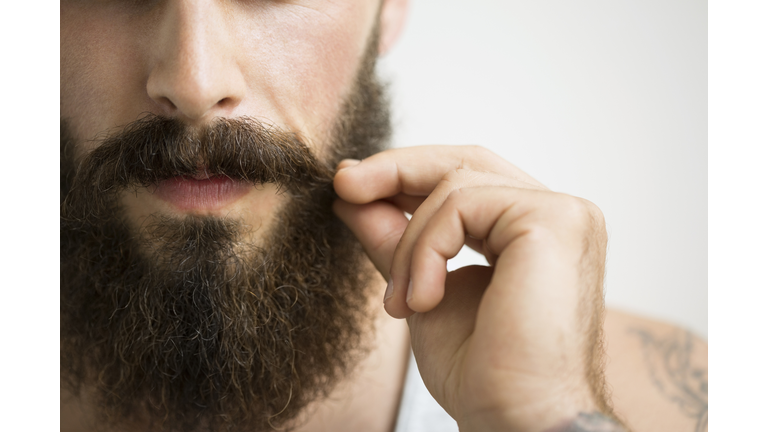 Close up of man touching mustache