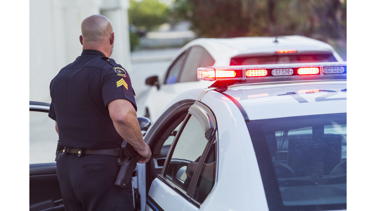 Police officer getting out of cruiser