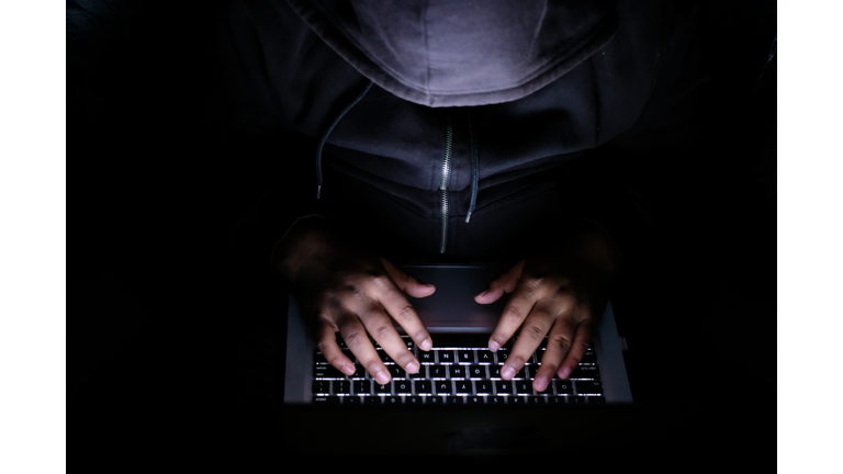 hacker Man with laptop stealing perdonal data from internet