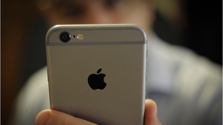 A man takes a photo with the front facing camera of an iPhone on November 15, 2017. The recently released Apple iPhone X has been scrutinized over possible security issues with it's face recognition feature which is used to unlook the phone