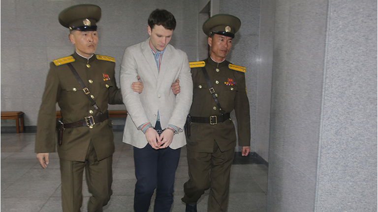 American student Otto Frederick Warmbier, center, arrives at a court for his trial in Pyongyang, capital of the Democratic People's Republic of Korea