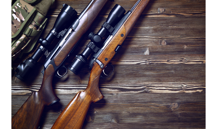 Hunting equipment on old wooden background.