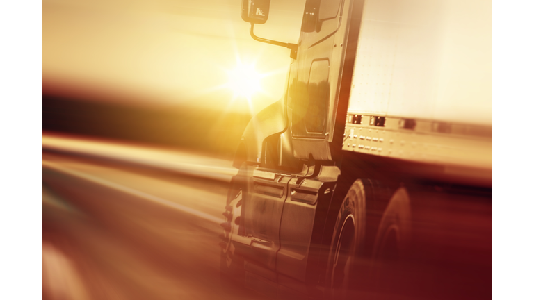 Tilt Shot Of Semi-Truck On Highway During Sunset