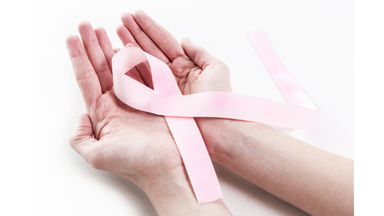 Closeup Old woman hand holding pink ribbon on white background ,Awareness breast cancer concept