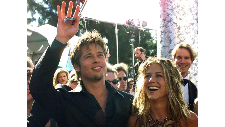 Actor Brad Pitt (L) waves to spectators as he arri