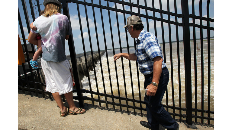 Onlookers watch as water flows through open bays at the Bonnet Carre Spillway in 2011. (Getty Images)