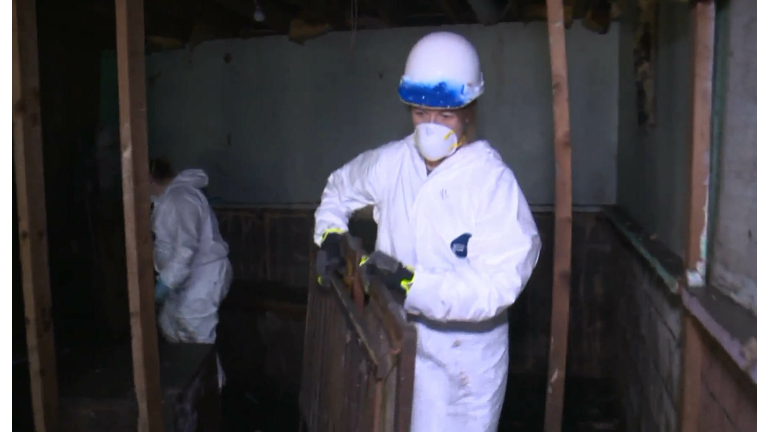 Cindy Axne helps with flooding clean up in Pacific Junction in April.  Photo WHO TV