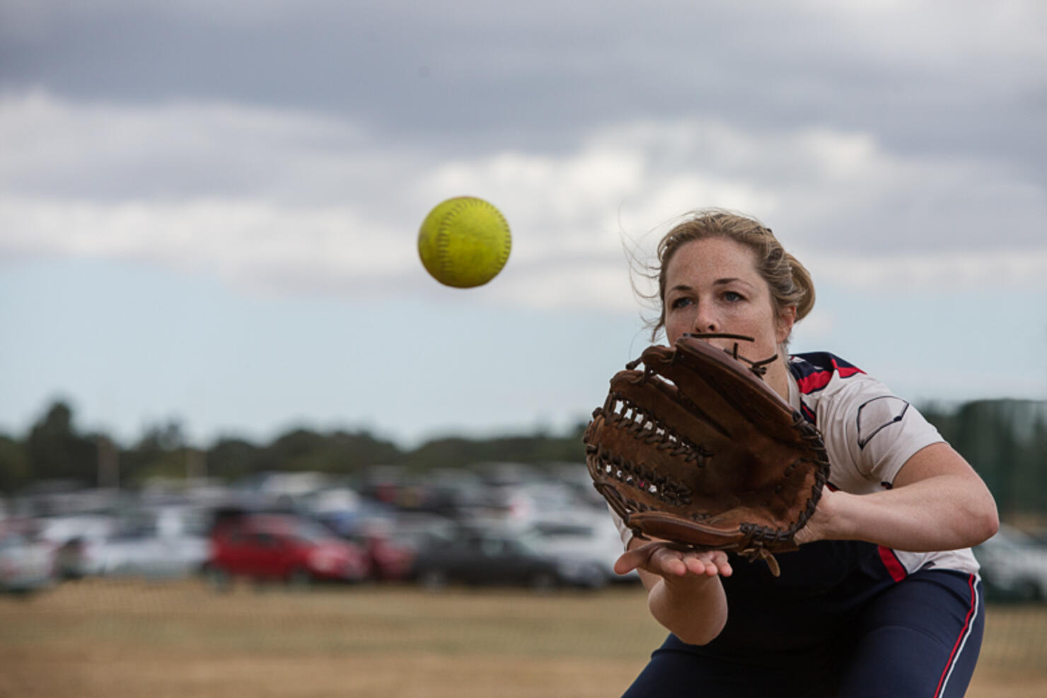 Female softball player catching the ball