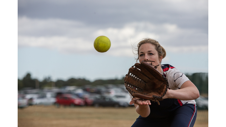 Female softball player catching the ball