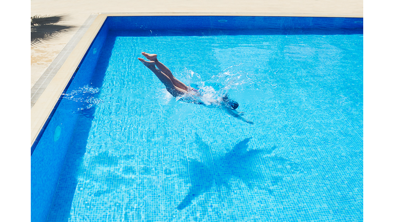 Young Women is Swimming in the Pool